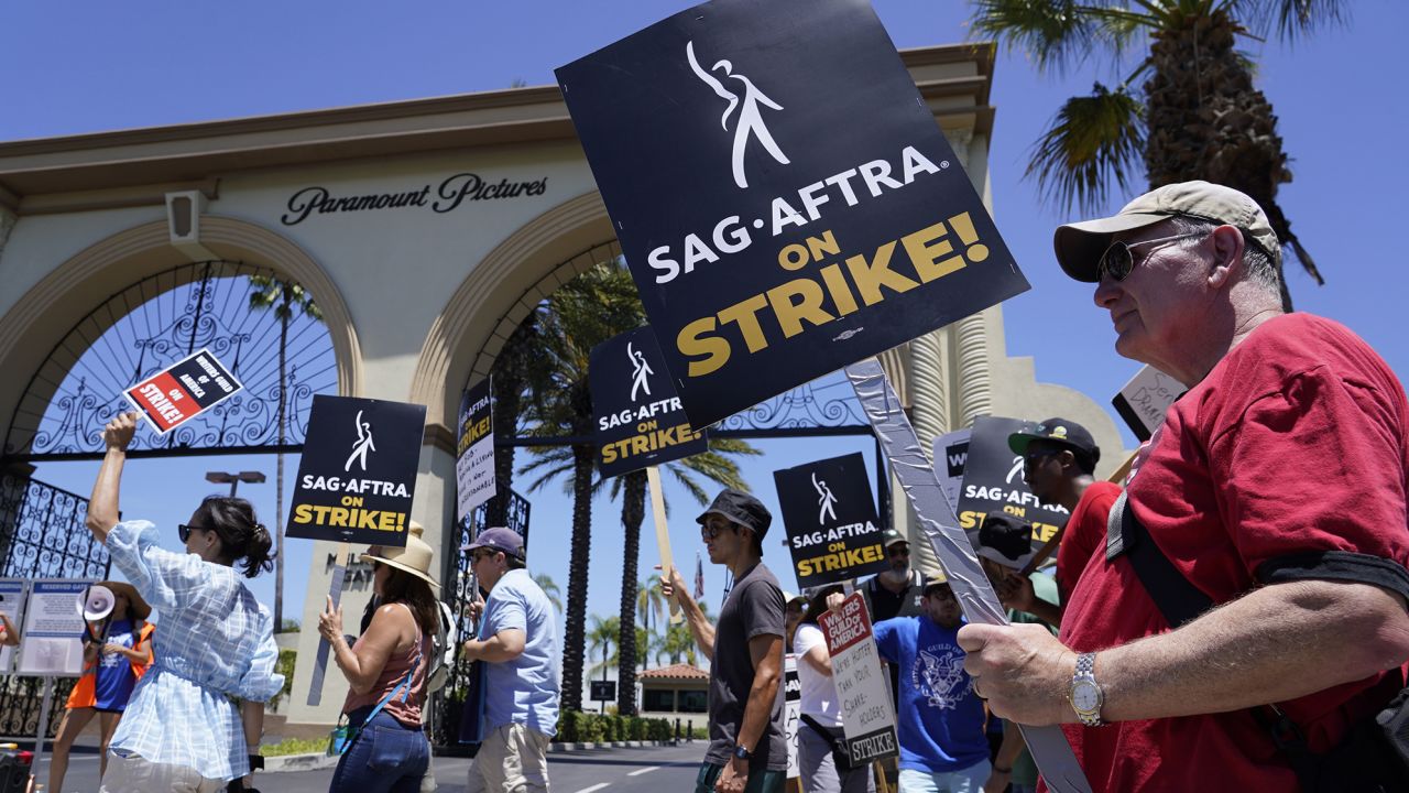 Striking writers and actors take part in a rally outside Paramount studios in Los Angeles on Friday, July 14, 2023. This marks the first day actors formally joined the picket lines, more than two months after screenwriters began striking in their bid to get better pay and working conditions.