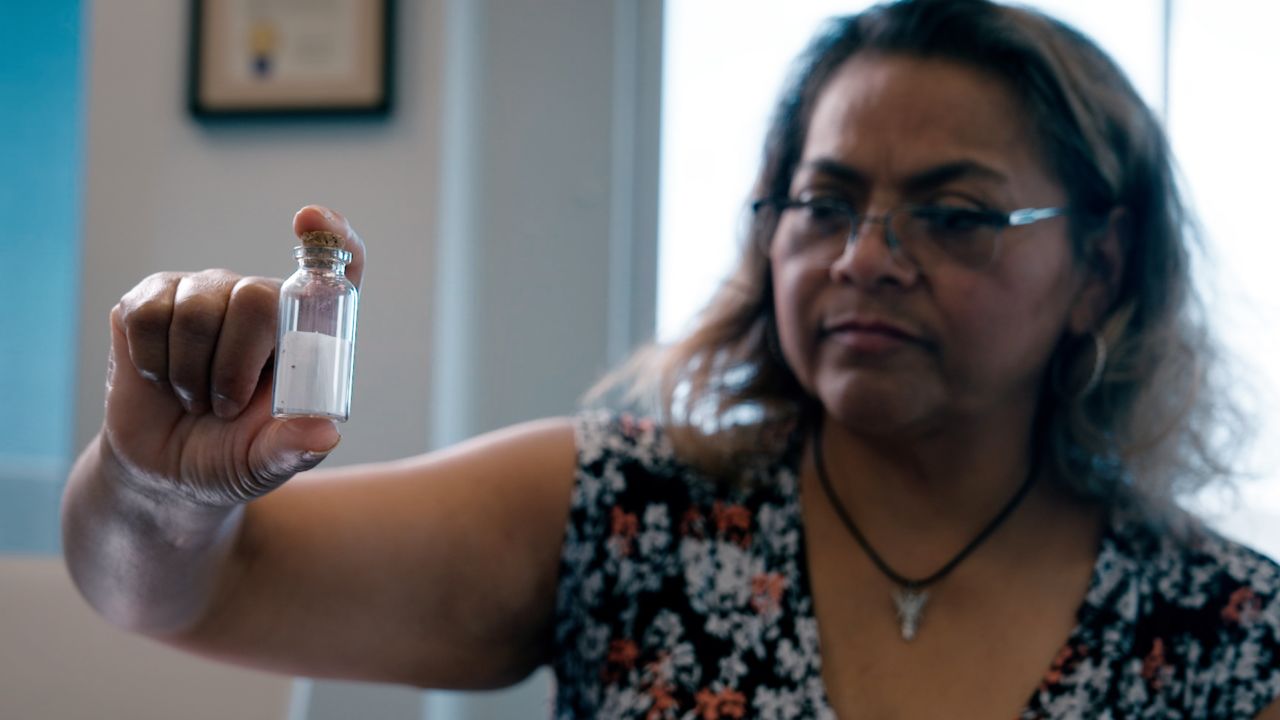 Velma Infante carries this vial which holds a print out of her son Gabriel's last heart beats. He died in June 2022.